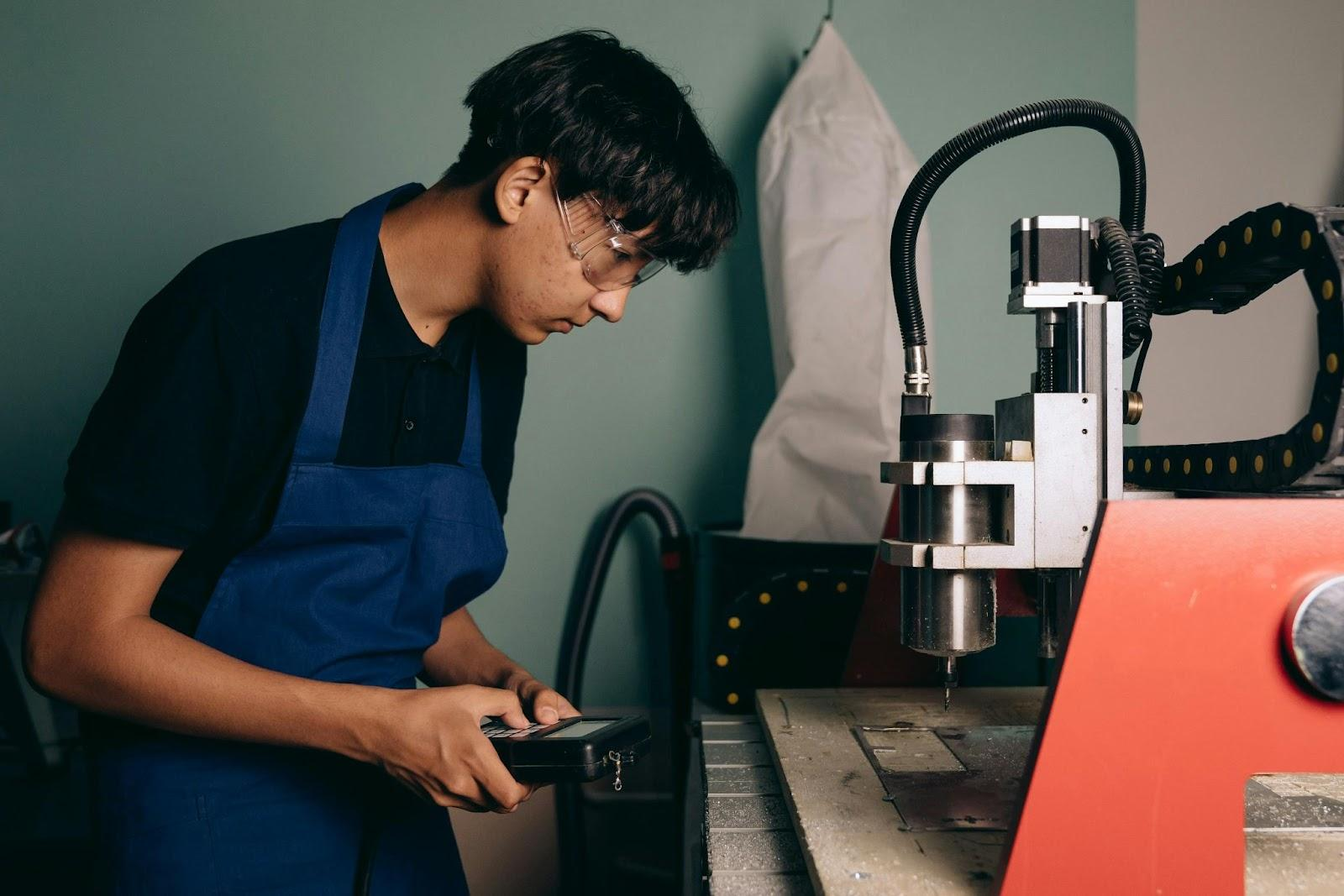 CNC Machinist Carrying Out Quality Control