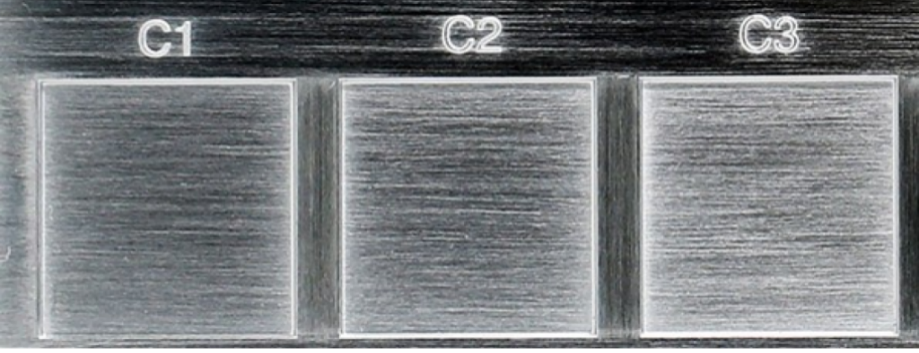 A detailed view of injection mold surface finishes showcasing different textures and precision levels